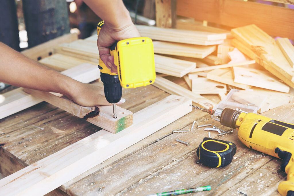 man using wireless power drill for home renovations